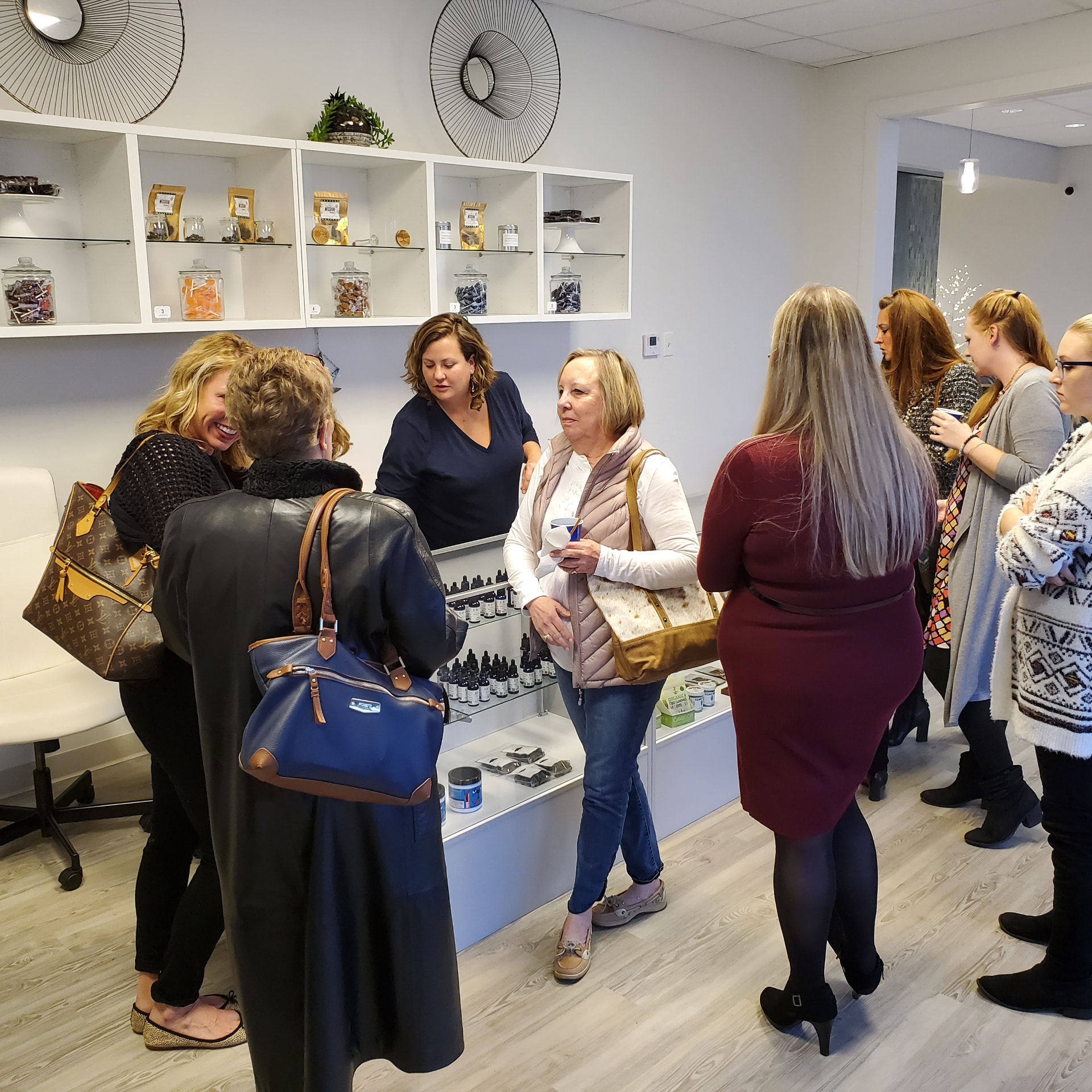 Katie of Blue Key CBD talking with a group of customers at an in-store CBD education event
